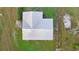 Top-down aerial view showcases roof of home with green grass and trees at 21055 Highway 441 N, Micanopy, FL 32667