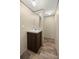 Well-lit bathroom with stylish vanity, and modern vinyl flooring at 21055 Highway 441 N, Micanopy, FL 32667