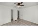 Minimalist bedroom with wood floors and ceiling fan with two doorways at 21055 Highway 441 N, Micanopy, FL 32667