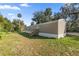 Single Gathering home featuring a tan exterior with matching front steps, surrounded by a lush green lawn at 21055 Highway 441 N, Micanopy, FL 32667