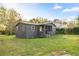 Charming gray single-story home with a welcoming front porch and well-maintained lawn at 21055 Highway 441 N, Micanopy, FL 32667