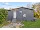 Back of a gray home with a white door and steps, including an AC unit at 21055 Highway 441 N, Micanopy, FL 32667