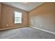 Cozy bedroom featuring neutral walls, carpet flooring, and a bright window at 23293 Nw Mallard Ave, Dunnellon, FL 34431