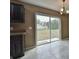 Dining area featuring gray tile floor, tan walls, black cabinets, and sliding glass doors to the backyard at 23293 Nw Mallard Ave, Dunnellon, FL 34431