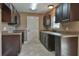 Kitchen showcasing dark wood cabinets, granite counters, and tiled floors at 23293 Nw Mallard Ave, Dunnellon, FL 34431