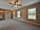 Spacious living room with plush carpeting, a ceiling fan, and lots of natural light at 23293 Nw Mallard Ave, Dunnellon, FL 34431