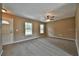 Spacious living room with plush carpeting, a ceiling fan, and lots of natural light at 23293 Nw Mallard Ave, Dunnellon, FL 34431