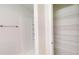 Bathroom with a built-in shower and a shelved storage closet for organization at 24150 Nw Banyan Ln, Dunnellon, FL 34431