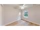 This is a bedroom with light wood floor, a ceiling fan, and a window at 24150 Nw Banyan Ln, Dunnellon, FL 34431