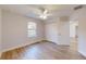 Bright bedroom with a ceiling fan, closet, and a window providing natural light, and hardwood flooring at 24150 Nw Banyan Ln, Dunnellon, FL 34431