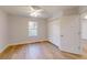 Bright bedroom with a ceiling fan, closet, and a window providing natural light, and hardwood flooring at 24150 Nw Banyan Ln, Dunnellon, FL 34431