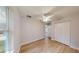 Bedroom featuring light wood floors, closet, ceiling fan and natural light at 24150 Nw Banyan Ln, Dunnellon, FL 34431