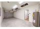 Spacious garage with concrete floors, an overhead door and access to the interior at 24150 Nw Banyan Ln, Dunnellon, FL 34431