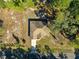 Overhead aerial view of the property, showcasing the roof, driveway, and surrounding mature trees at 29 Guava Pass, Ocklawaha, FL 32179