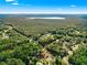 Gorgeous aerial perspective of the property situated amidst a dense forest, not far from a large lake at 29 Guava Pass, Ocklawaha, FL 32179