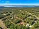 Scenic aerial view of the property surrounded by lush greenery, highlighting its serene location near a lake at 29 Guava Pass, Ocklawaha, FL 32179