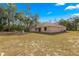 Spacious backyard with a large lot and mature trees offering privacy and a peaceful setting at 29 Guava Pass, Ocklawaha, FL 32179