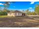 Expansive backyard with mature trees offering a private outdoor space at 29 Guava Pass, Ocklawaha, FL 32179