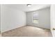 Cozy bedroom with carpet, neutral paint, a window letting in natural light and an electrical outlet at 29 Guava Pass, Ocklawaha, FL 32179