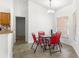 Bright dining area featuring a modern chandelier, tile floors, and a table with red chairs at 29 Guava Pass, Ocklawaha, FL 32179