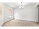 Bright dining room featuring a chandelier light fixture and a large window letting in plenty of light at 29 Guava Pass, Ocklawaha, FL 32179