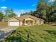 Charming single-story home with manicured lawn, neutral stucco, columns, and two-car garage at 29 Guava Pass, Ocklawaha, FL 32179