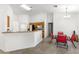 Bright kitchen and dining area with white walls, tile flooring, and breakfast bar at 29 Guava Pass, Ocklawaha, FL 32179