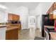 Well-lit kitchen with dark appliances, wood cabinets, and tile backsplash at 29 Guava Pass, Ocklawaha, FL 32179