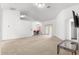 Bright living room with carpet flooring and sliding glass door leading to the outdoors at 29 Guava Pass, Ocklawaha, FL 32179