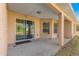 Covered patio with stucco columns and a sliding glass door to the interior at 29 Guava Pass, Ocklawaha, FL 32179