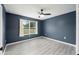 Bedroom with modern vinyl flooring, a window with natural light, and a ceiling fan at 3705 Se 137Th Ln, Summerfield, FL 34491