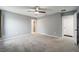 Spacious carpeted bedroom features a ceiling fan, closet and private bathroom at 3705 Se 137Th Ln, Summerfield, FL 34491