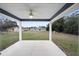 Covered patio with a ceiling fan, perfect for enjoying the backyard views at 3705 Se 137Th Ln, Summerfield, FL 34491