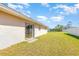 Expansive backyard featuring a sliding glass door and a well-maintained lawn at 434 Bar Ct, Kissimmee, FL 34759