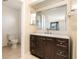 Bathroom featuring dark wood vanity, large mirror, and updated fixtures at 434 Bar Ct, Kissimmee, FL 34759