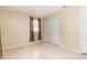 Bedroom with tile floor, window with curtains and a closet with sliding doors at 434 Bar Ct, Kissimmee, FL 34759