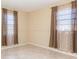 Cozy bedroom with tile flooring and windows with patterned curtains at 434 Bar Ct, Kissimmee, FL 34759