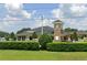 Community clubhouse showcasing stone accents, dark roof, and manicured landscaping in neighborhood at 434 Bar Ct, Kissimmee, FL 34759