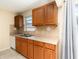 Kitchen featuring wood cabinets, stainless steel sink, and tile backsplash at 434 Bar Ct, Kissimmee, FL 34759