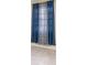 Window with patterned blue curtains at 434 Bar Ct, Kissimmee, FL 34759