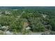 Aerial view of a home with a large lot, blending harmoniously into the surrounding verdant landscape at 4445 Sw Azalea Ct, Dunnellon, FL 34431