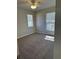 Bedroom featuring a ceiling fan, two windows, and neutral carpet at 4691 Se 138Th Pl, Summerfield, FL 34491