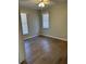 Bedroom featuring wood-look floors, a ceiling fan and two windows at 4691 Se 138Th Pl, Summerfield, FL 34491