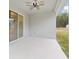 Covered back porch with ceiling fan overlooking the backyard at 47 Sequoia Loop, Ocklawaha, FL 32179