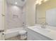 Bathroom featuring a shower-tub combo, white vanity, and wood-look tile floors at 47 Sequoia Loop, Ocklawaha, FL 32179