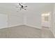 Large bedroom with a ceiling fan, wood-look tile floors, with ensuite bathroom at 47 Sequoia Loop, Ocklawaha, FL 32179