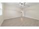 Spacious bedroom featuring a ceiling fan, wood-look tile flooring, and an open doorway to another room at 47 Sequoia Loop, Ocklawaha, FL 32179