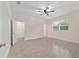 Large bedroom with a ceiling fan, wood-look tile floors, and multiple doorways at 47 Sequoia Loop, Ocklawaha, FL 32179