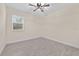 Neutral bedroom with a ceiling fan and tile floors at 47 Sequoia Loop, Ocklawaha, FL 32179