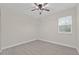 Neutral bedroom with a ceiling fan and tile floors at 47 Sequoia Loop, Ocklawaha, FL 32179